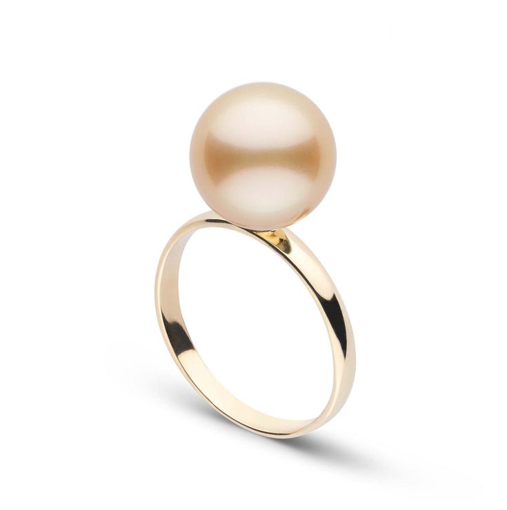 a gold ring with a white pearl on it