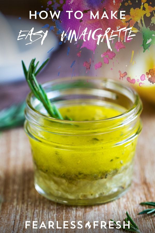 a jar filled with yellow liquid sitting on top of a wooden table