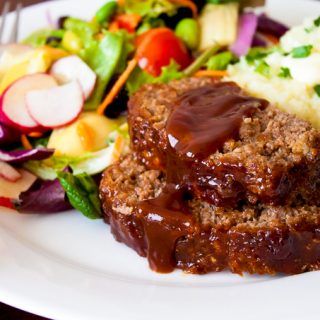 meatloaf, mashed potatoes and salad on a white plate