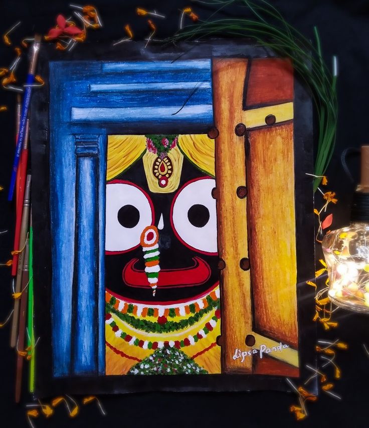 an artistic painting on a wooden frame next to some lights and candles, with a lantern in the background