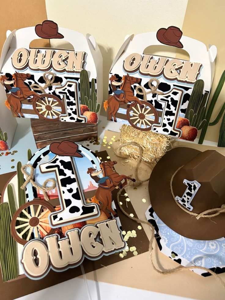 three cowboy themed birthday cards on a table with hats and other items to make it look like they are made out of paper