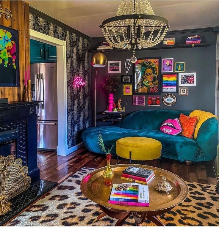 a living room filled with furniture and a chandelier hanging from the ceiling over a fire place