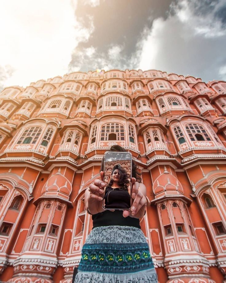 a person taking a selfie in front of a building