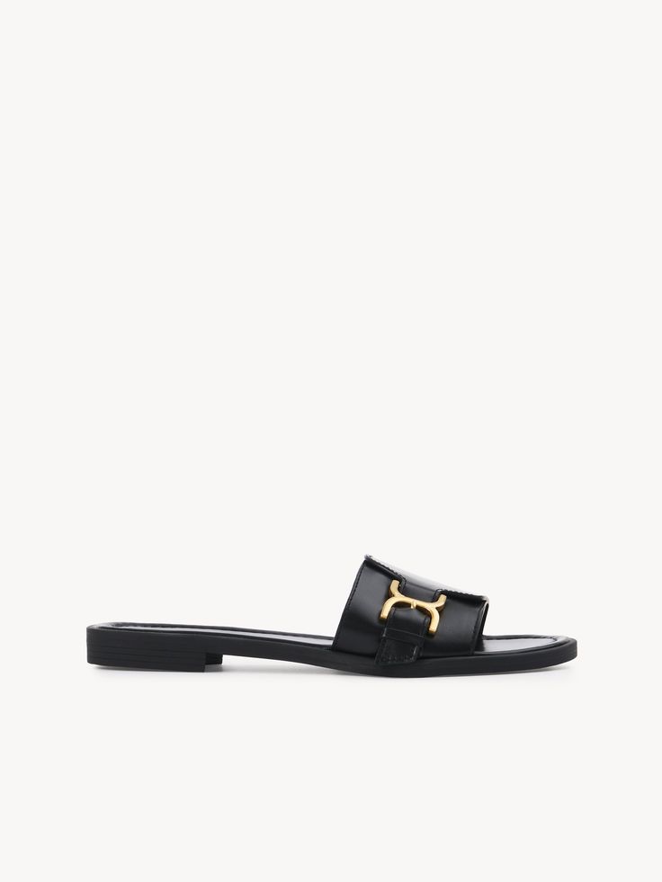 Chloé Marcie Slide | Chloé US Classic Slides With Buckle Closure, Elegant Mules With Buckle Closure In Slide Style, Elegant Slide Mules With Buckle Closure, Elegant Formal Flat Slides, Elegant Gold Flat Slides, Elegant Flat Slides For Formal Occasions, Elegant Slip-on Sandals With Buckle Closure, Classic Leather Slides With Buckle Closure, Classic Slip-on Sandals With Tang Buckle