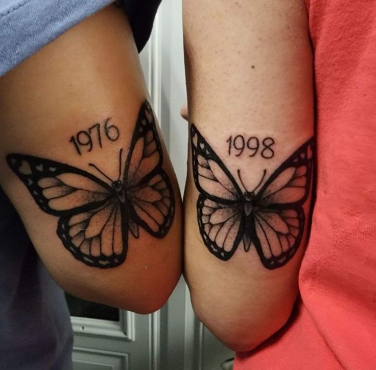 two people with butterfly tattoos on their legs