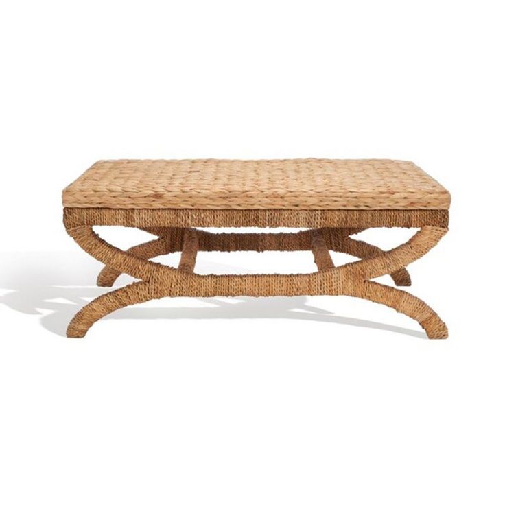 a wicker coffee table with a wooden frame and foot rests on an isolated white background