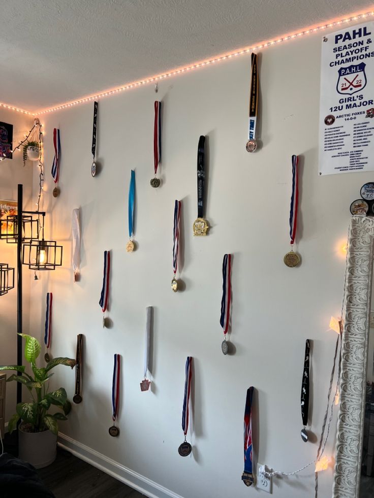 a wall with several medals hanging on it