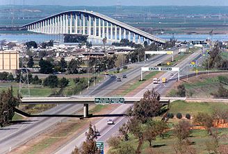 an aerial view of a highway and bridge