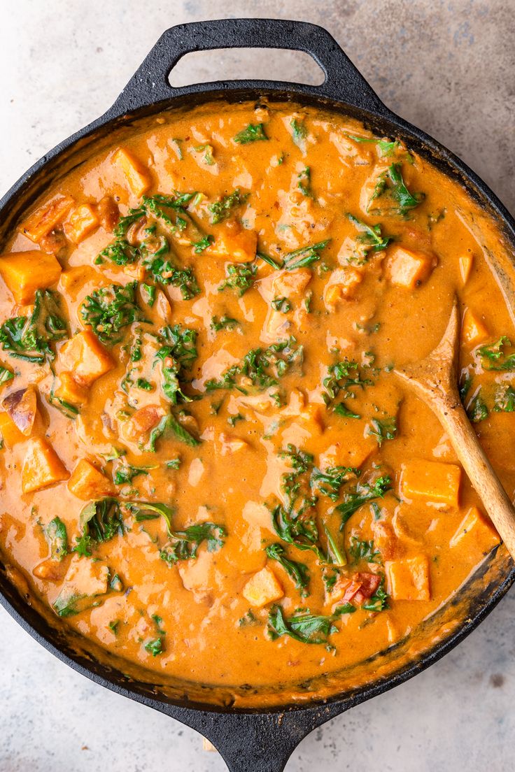 a skillet filled with curry and tofu