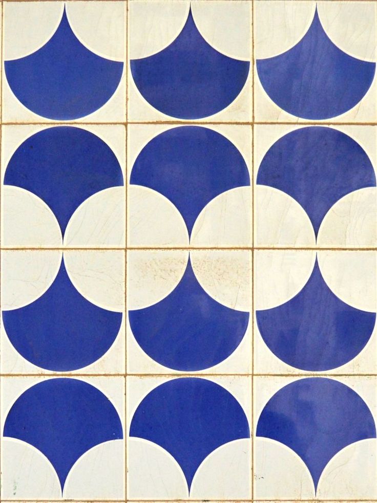 a blue and white tile with circles on the bottom, in different directions to make it look like they have been made out of ceramic tiles