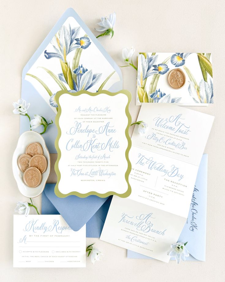 the wedding stationery is laid out on top of each other