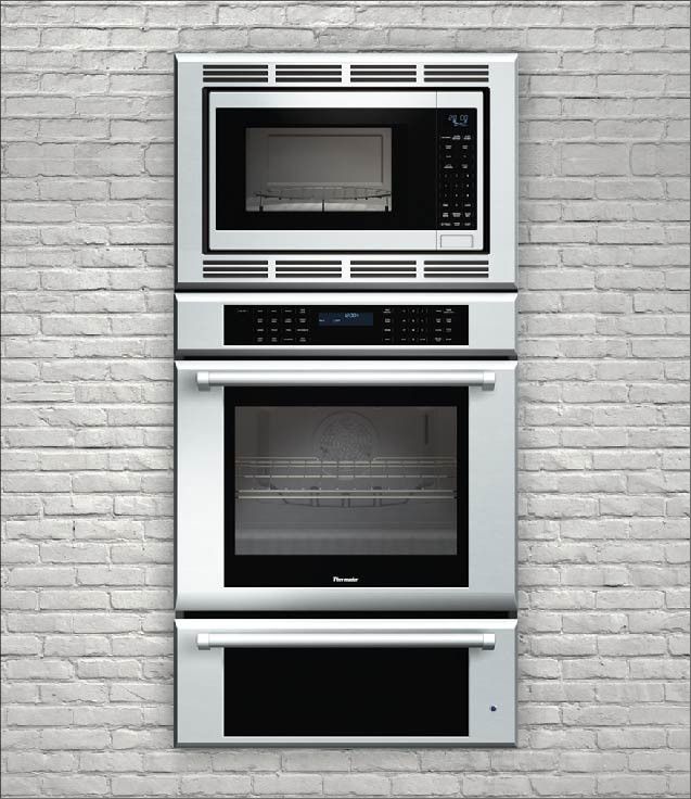 two built in ovens mounted on a brick wall, one is white and the other is black