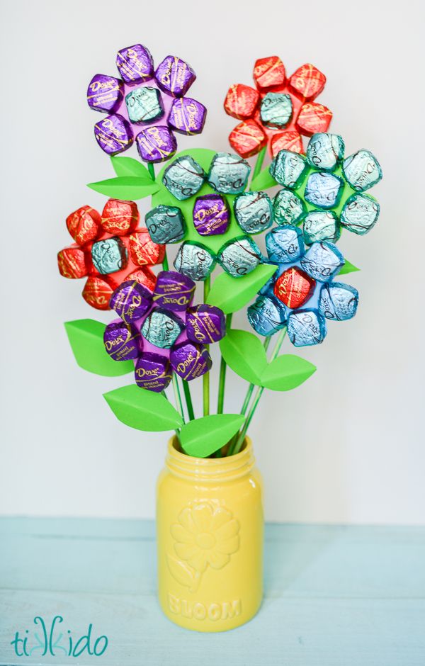 a vase filled with assorted chocolates on top of a table