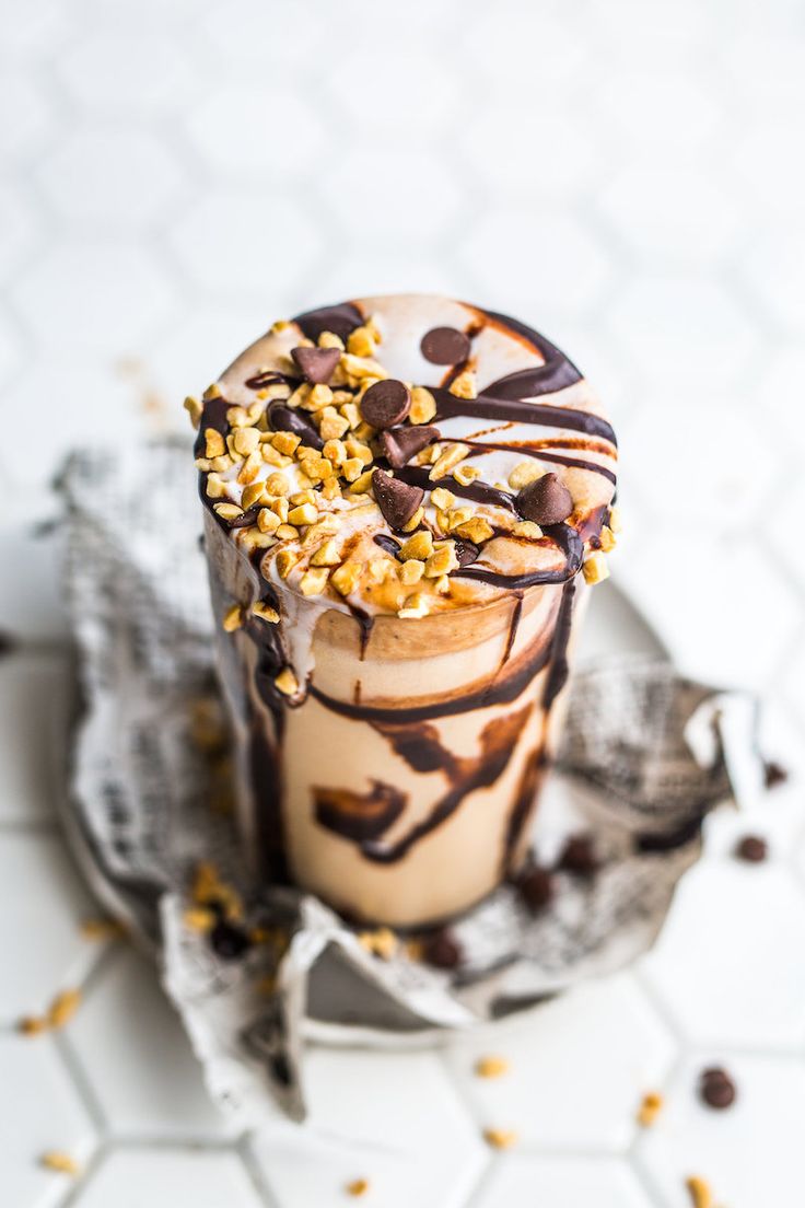 an ice cream sundae with chocolate and nuts on top