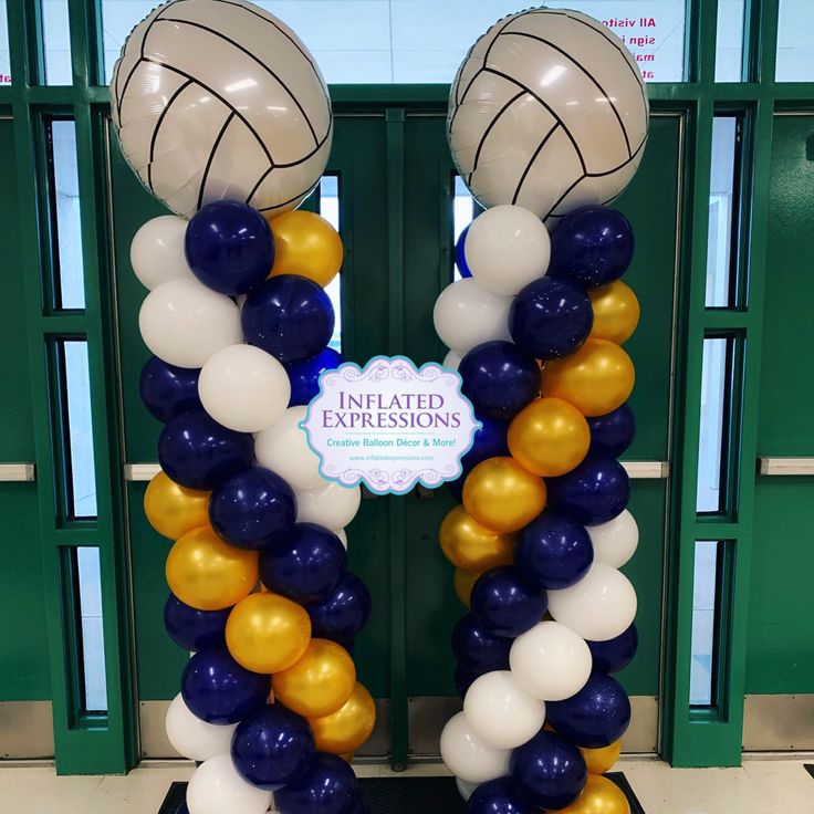 the balloon arch is decorated with basketballs and white, blue, and gold balloons