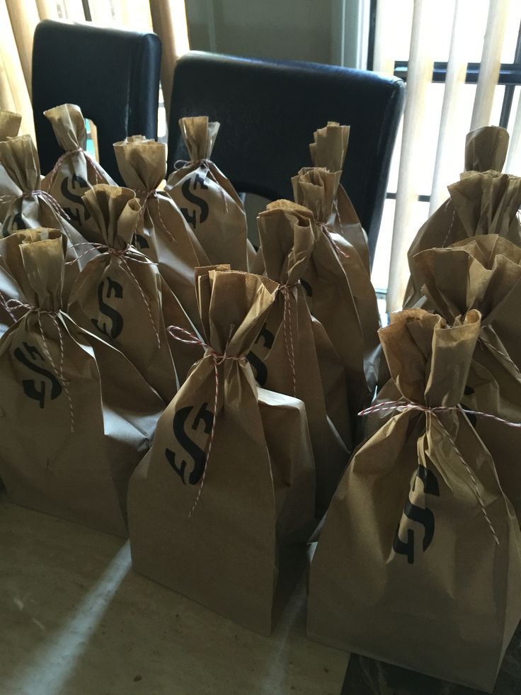 several brown bags with numbers on them sitting in front of a window and some chairs