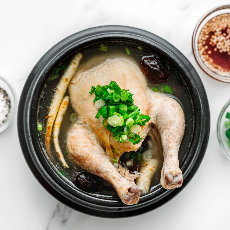 a bowl filled with meat and vegetables on top of a table