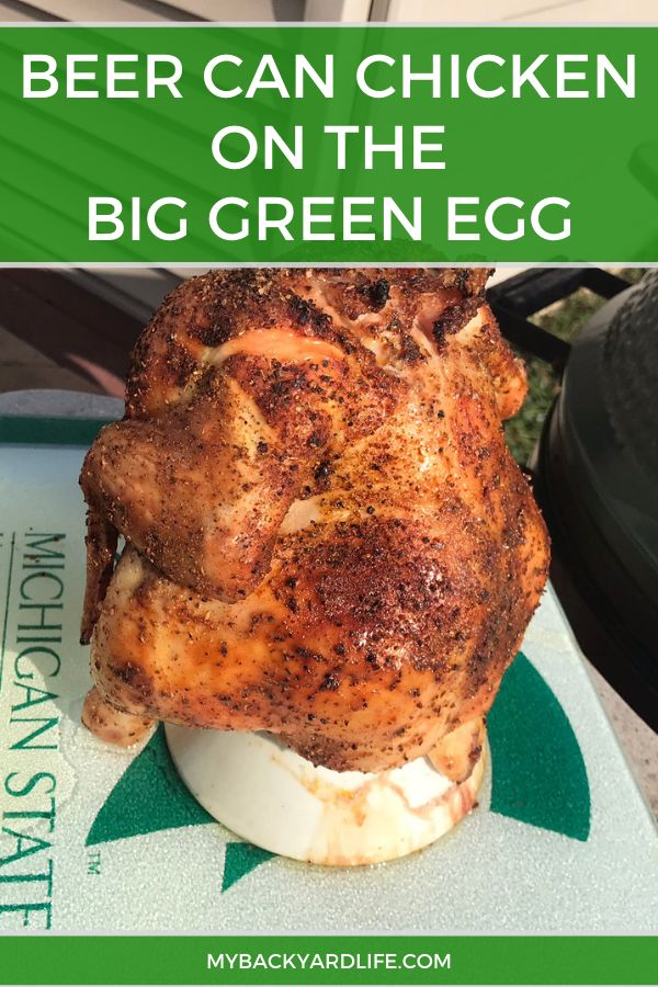 a chicken sitting on top of an egg in the middle of a green tray with text overlay that reads beer can chicken on the big green egg