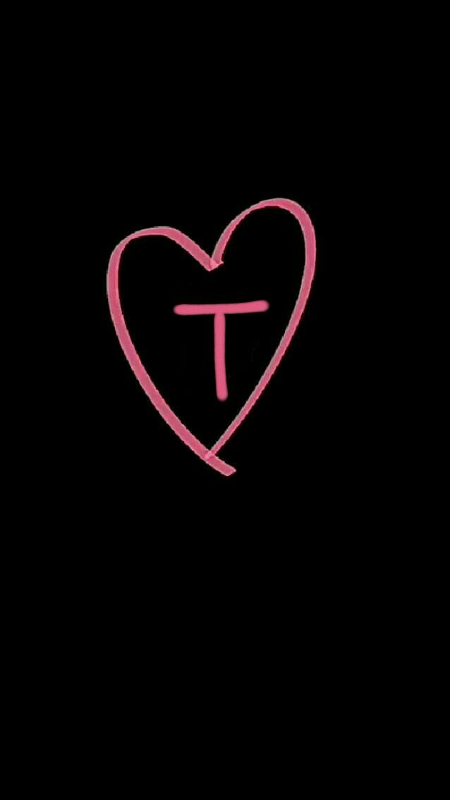 a pink heart with the letter t in it's center on a black background