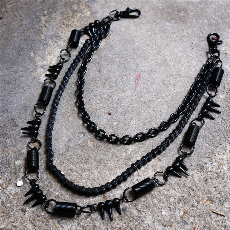 Barbed Wire Belt Chain A barbed wire style hanging wallet chain with a single loop clip at each end. Three chains are layered to hang - one is bicycle chain style, one a standard link chain, and one with a mix of barbed wire/spikes, springs and rings. Length: 23.6"-31.5" (60-80cm.) Punk Style Metal Double Chain Necklace, Edgy Double Chain Link Necklace, Punk Style Black Metal Chain Necklace, Black Double Chain Link Necklace, Black Punk Jewelry With Chain Strap, Punk Black Jewelry With Chain Strap, Black Edgy Jewelry With Chain Strap, Punk Jeans, Pants Chain