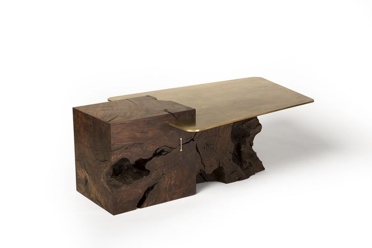 a wooden bench made out of wood with a metal table top on one end and a piece of tree bark on the other side