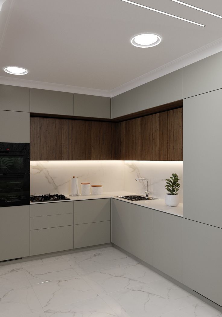 a modern kitchen with marble counter tops and white walls, along with recessed lighting