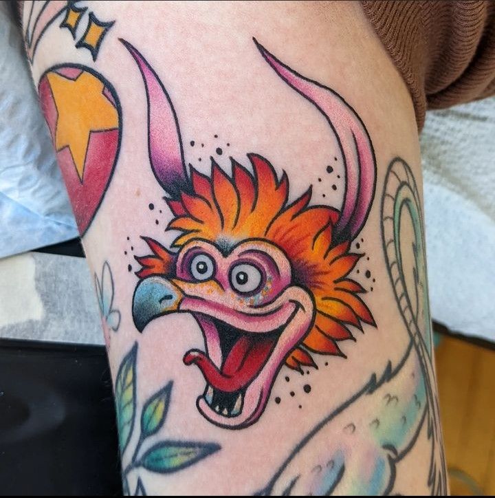 a close up of a person's leg with tattoos on it and an animal