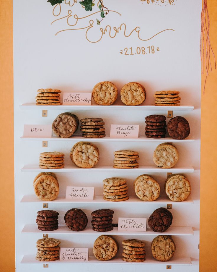 cookies and cookies are displayed on shelves in front of a wedding sign that says, i do