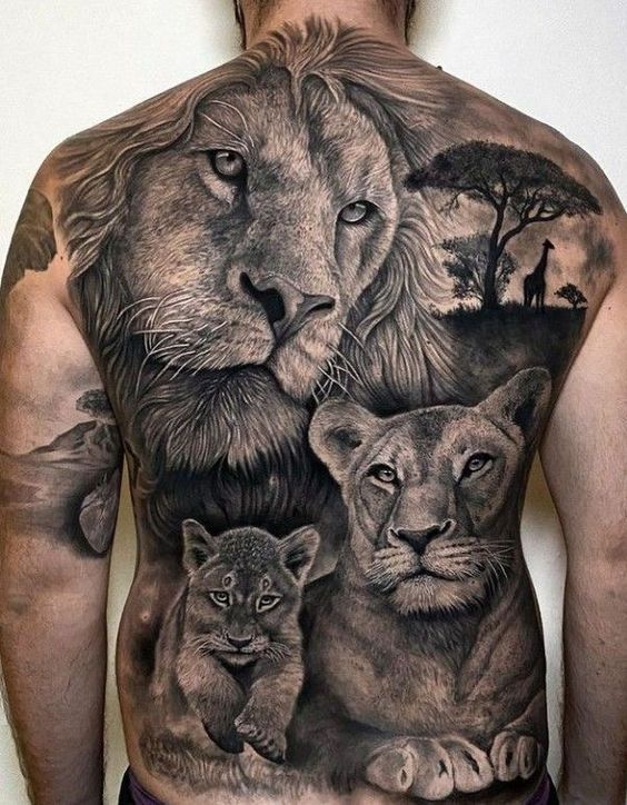 a man with tattoos on his back and two lions in front of the lion is shown