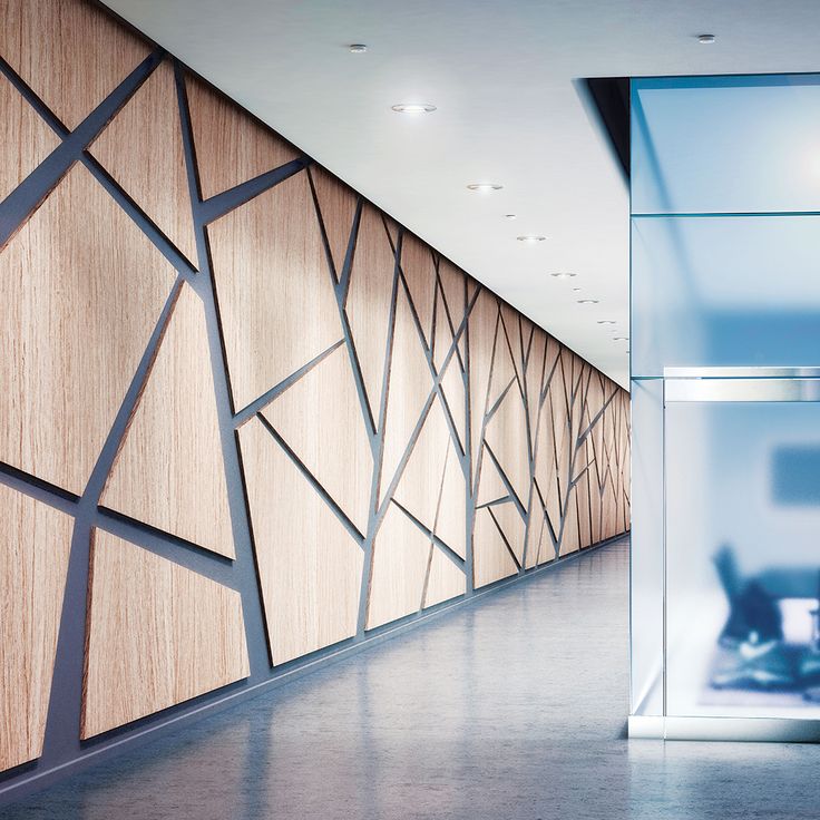 an empty room with wood paneling and glass walls