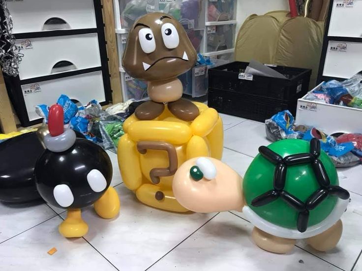 three inflatable toys sitting on top of a white tile floor next to each other