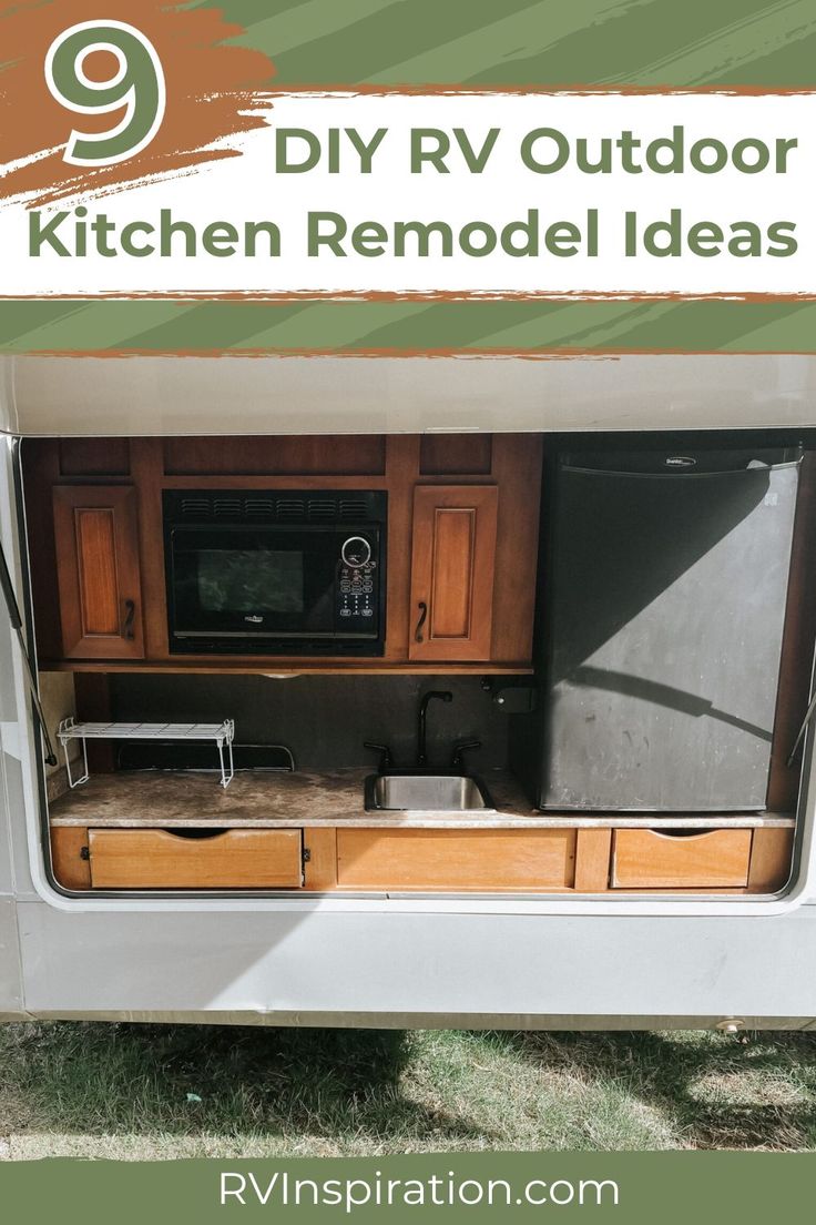 an rv kitchen with the door open to reveal it's storage area