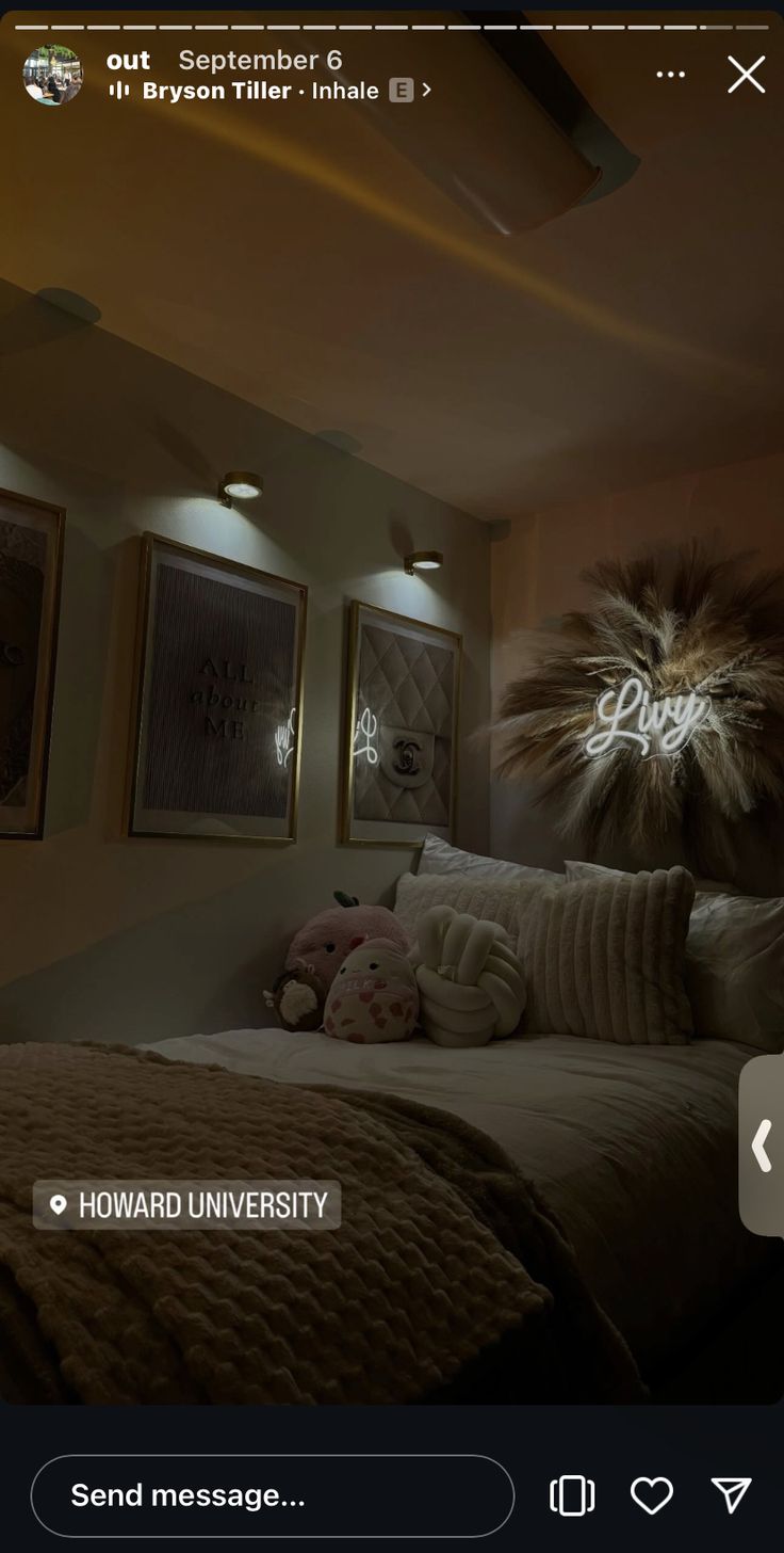 a bed room with a neatly made bed and two pictures on the wall above it