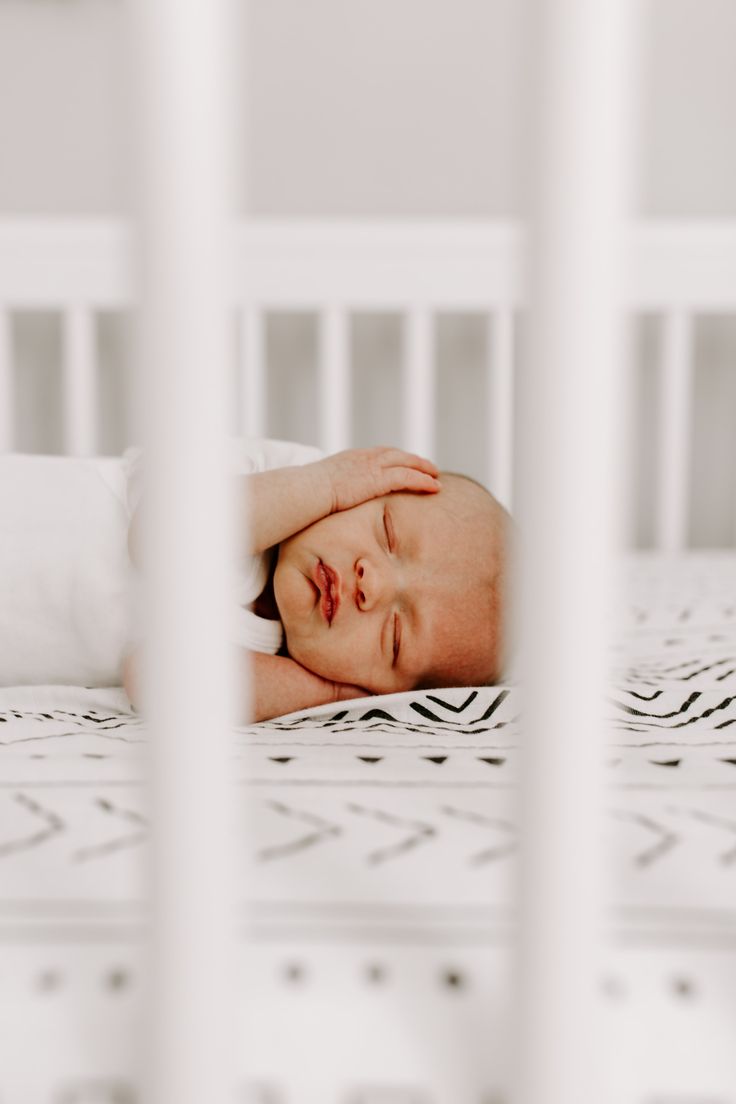 a baby is laying down in his crib