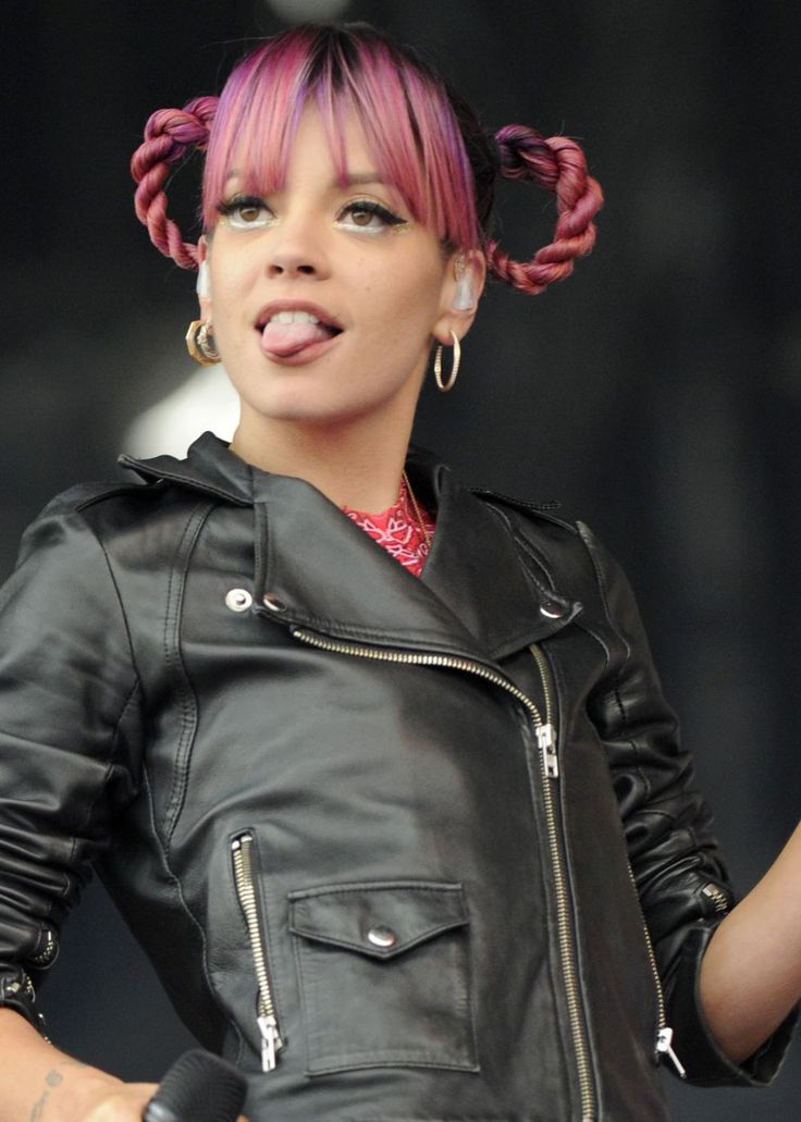 a woman with pink hair wearing a black leather jacket