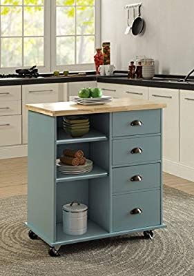 a blue kitchen island with wooden top and drawers