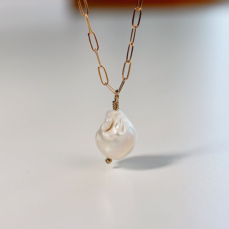 Baroque Pearl Gold filled necklace. Perfect for your wedding day or It's a lovely birthday gift, Christmas gift or bridesmaids gift. *** Pearl is natural freshwater baroque pearl***Chain and clasp is 14k gold filled***Wire is 14k gold filled. LENGTHChoose your length from drop down menu14 inches16 inches18 inchesAll necklaces come with additional 1" gold filled extender chain. Gold Pearl Pendant Necklace In 14k Gold Filled, Pear-shaped Baroque Pearl Chain Jewelry, Yellow Gold Baroque Pearl Drop Jewelry, Baroque Pearl Teardrop Jewelry With Pearl Chain, Teardrop Baroque Pearl Chain Jewelry, Gold Baroque Pearl Drop Necklace, Baroque Pearl Briolette Necklace In Pearl White, Gold Baroque Pearl Drop Jewelry, Gold Drop Baroque Pearl Necklace