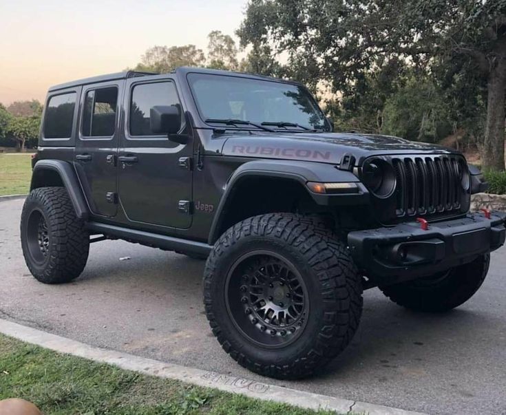 a black jeep is parked on the street