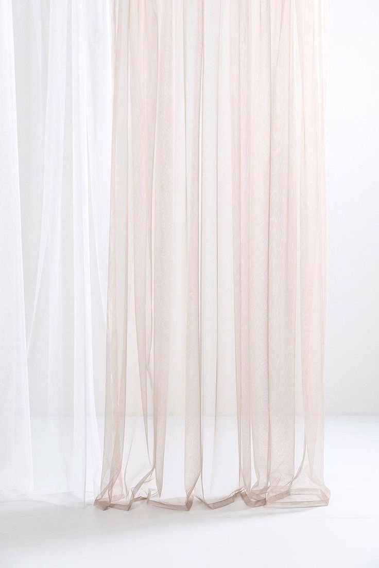 a white curtain with sheer fabric hanging from it's side