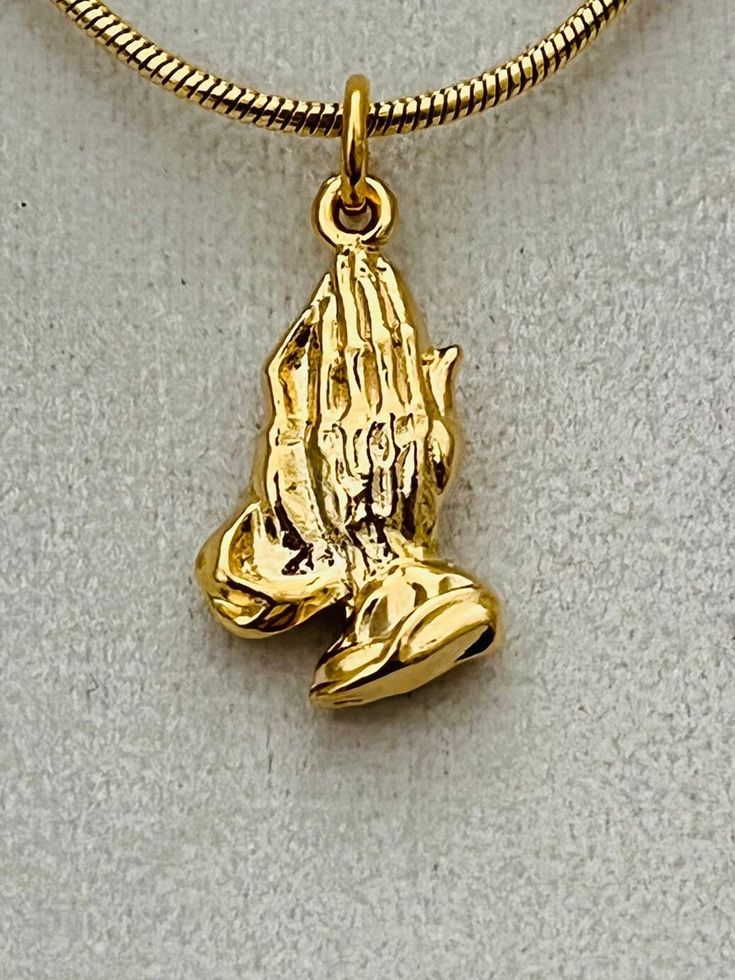 "Unique gold plated Praying Hands pendant from our family's own collection.  The pendant measures 1 1/4\" long x 1/2\" x 1mm thick and comes with a gold filled snake chain available in four sizes." Spiritual 14k Gold-filled Charm Necklace With Adjustable Chain, 14k Gold-filled Spiritual Charm Necklace With Adjustable Chain, 14k Gold Filled Spiritual Pendant Necklace, Spiritual 14k Gold Filled Pendant Necklace, Spiritual 14k Gold-filled Charm Necklace, Spiritual 14k Gold Filled Charm Necklace, Spiritual 14k Gold Filled Tarnish-resistant Jewelry, Spiritual 14k Gold Filled Yellow Gold Charm Necklaces, Spiritual 14k Gold-filled Yellow Gold Charm Necklace