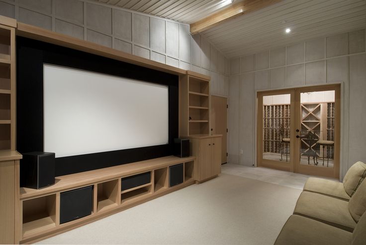 a large screen mounted to the side of a wooden entertainment center in a living room