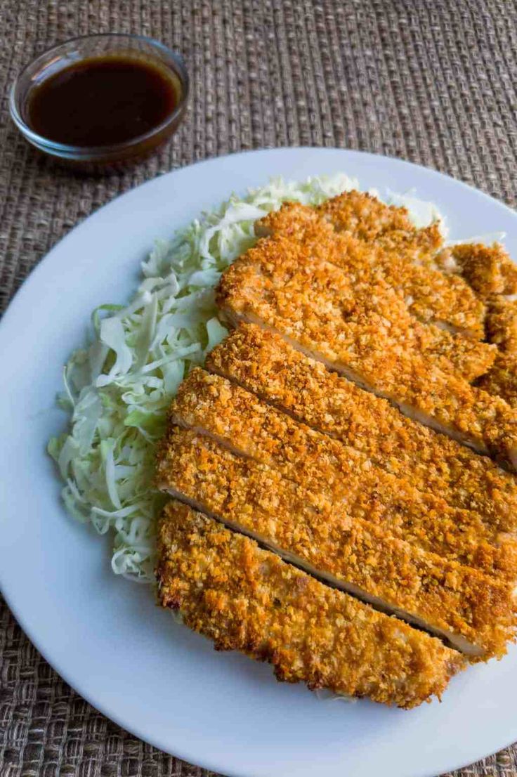 a white plate topped with meat and cole slaw