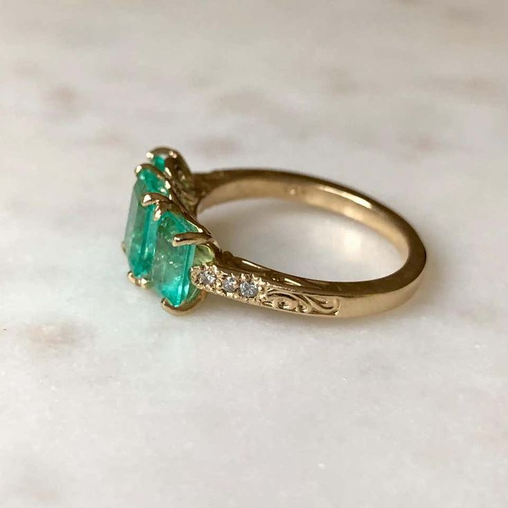 For Sale on 1stDibs - This stunning Colombian emerald 18k gold three stone engagement ring features in center; 1.40ct vs glowing-lustrous Colombian emerald measuring 7.85x6.08mm. Gold Three Stone Engagement Ring, Emerald Three Stone Ring, Three Stone Engagement Ring, Colombian Emeralds, Stone Engagement Ring, Three Stone Engagement, Three Stone Engagement Rings, Stone Engagement, Emerald Engagement Ring