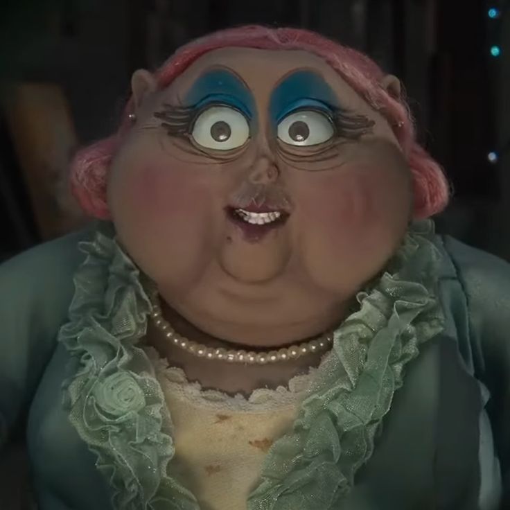 an animated woman with pink hair and blue eyes is making a funny face while wearing a green dress