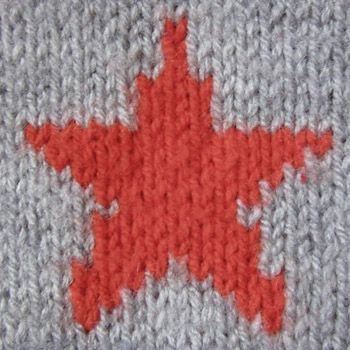 an orange star is on the side of a gray knitted surface