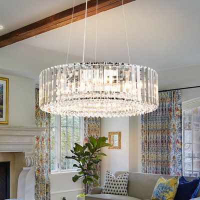 a living room filled with furniture and a large chandelier hanging from the ceiling