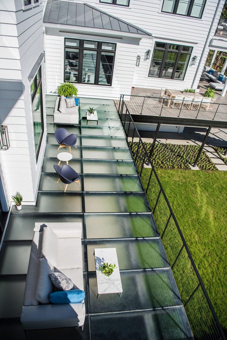 an aerial view of a house with stairs leading up to the upper floor and patio area