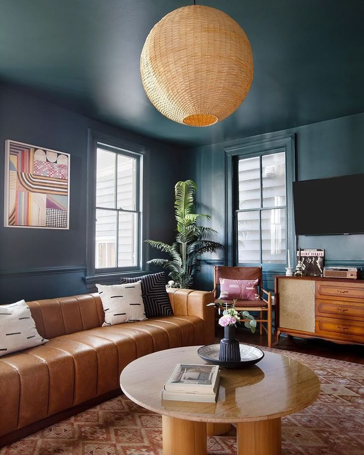 a living room filled with furniture and a flat screen tv mounted to the side of a wall