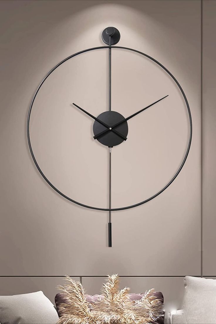 a large clock mounted to the side of a wall next to a couch in a living room