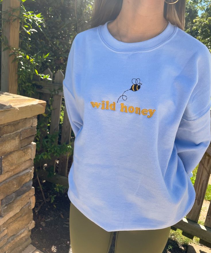 Enjoy a little wild honey with this adorable Bee Crewneck Sweatshirt. This sweatshirt features long sleeves, a crew neckline, and beautiful front embroidery. The Unisex Sizing makes the sweatshirt run slightly larger than your average sweatshirt for women. Most men find their normal size to be more snug. If you want a slightly looser fit, size up one size. Please check out our size chart for measurements to ensure an accurate fit. PLEASE BE SURE TO INPUT YOUR CORRECT SIZE/COLOR + SHIPPING ADDRES Aesthetic 00s, Disney Bachelorette, Nike Custom, Wild Honey, Embroidery Sweatshirt, Cute Embroidery, Sweatshirt For Women, Y2k Aesthetic, Long Sleeve Pullover